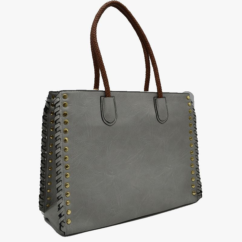 Gray faux leather tote with braided handles and gold studs on the outer edge