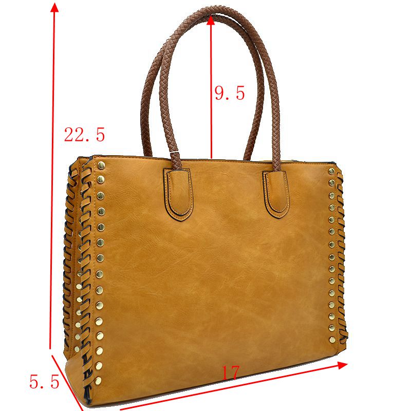 Mustard faux leather tote with studded sides, whipstitch trim, and twin top handles