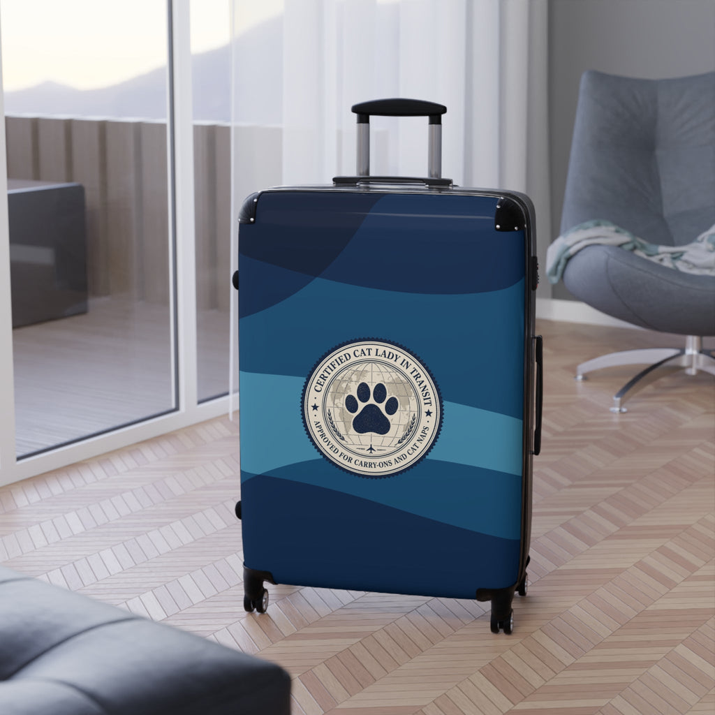 Blue hard-shell suitcase upright with paw seal on front