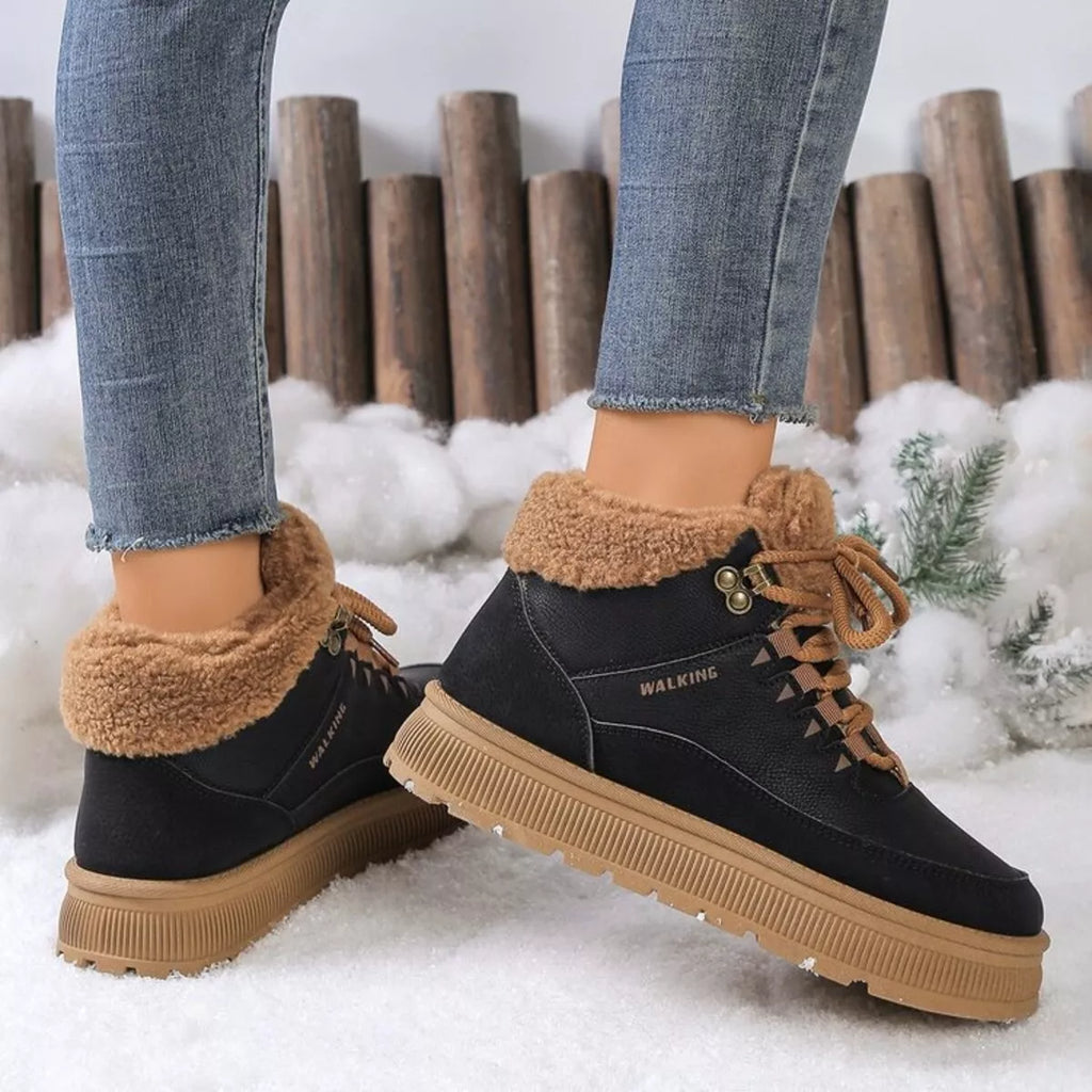 Black platform ankle boots with tan fleece collar and lace-up front; treaded sole
