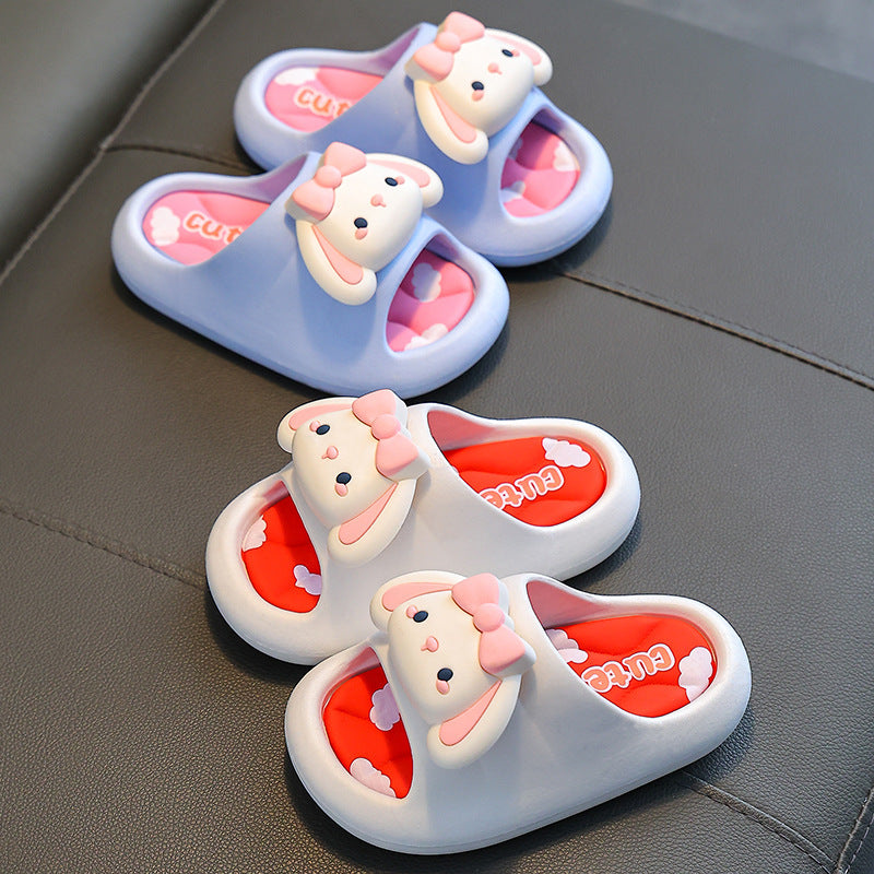 Kids bunny slide slippers in light blue with pink interior lining and bow detail