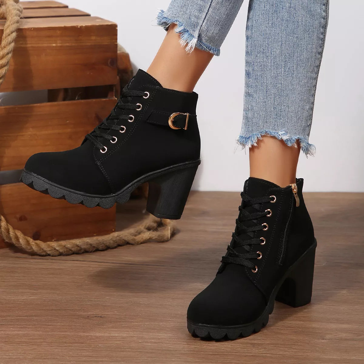 Black lace-up ankle boots with chunky block heel and side buckle strap.