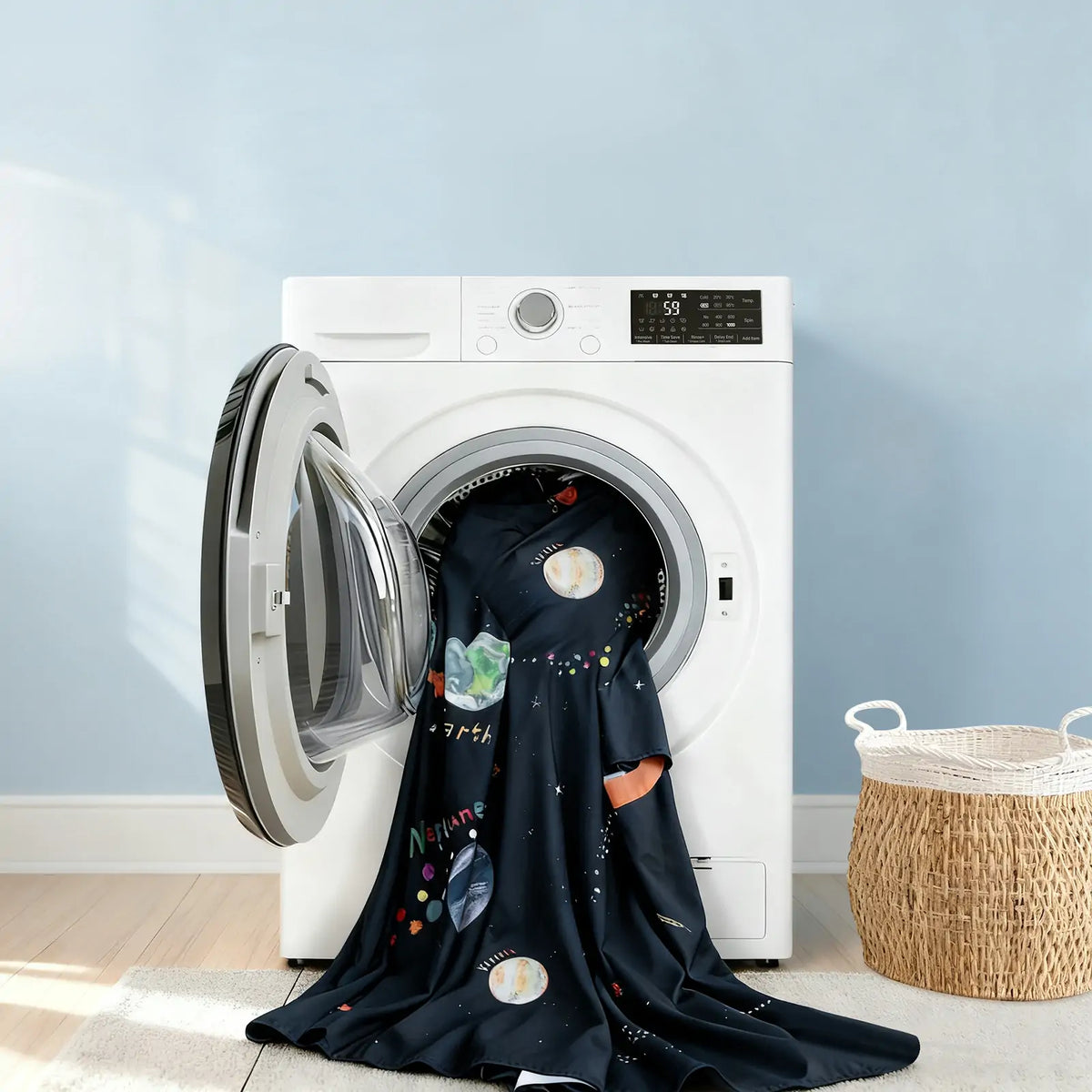 Dark navy space print kids tent fabric draped in a washing machine drum