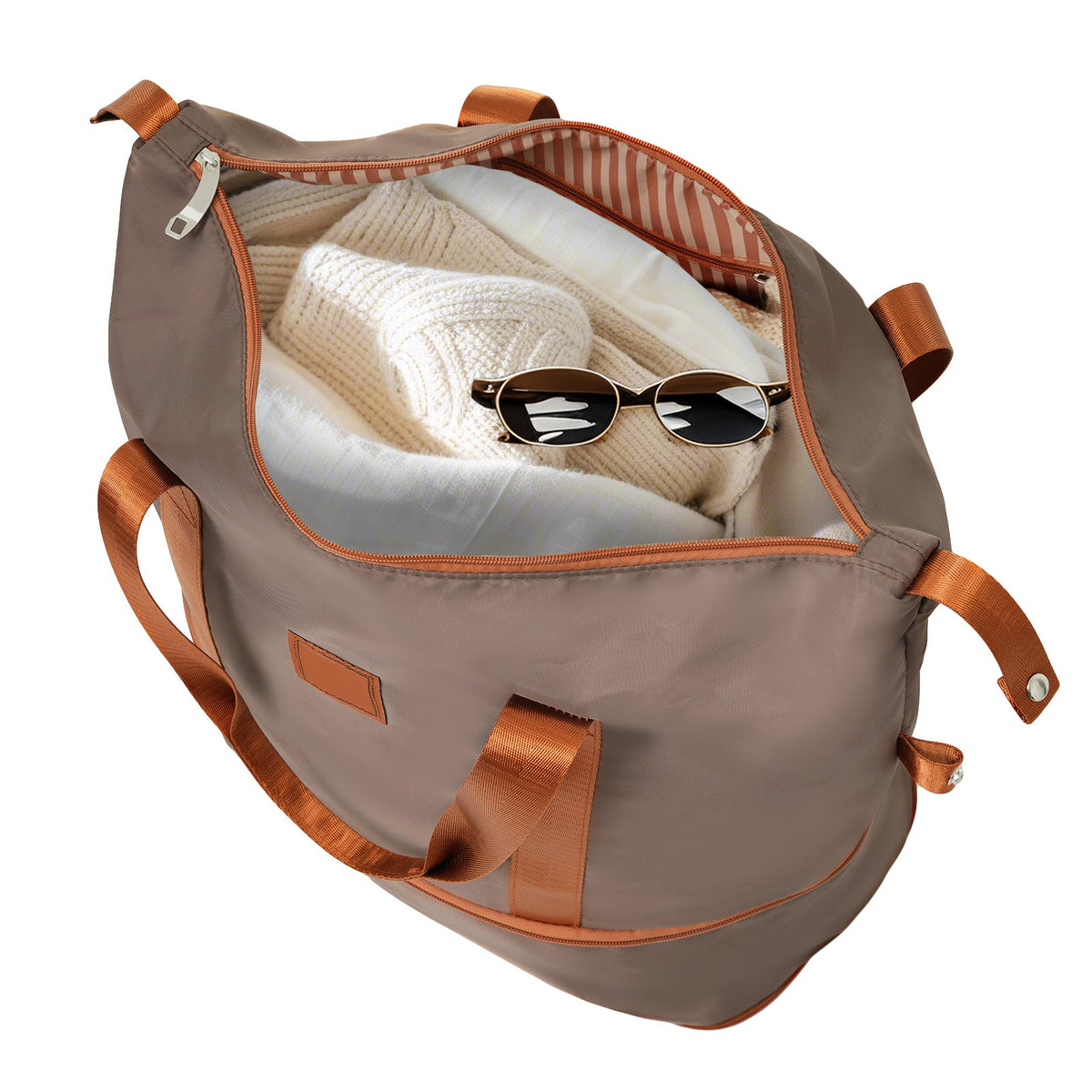 Gray duffle bag with copper straps and open top showing internal items
