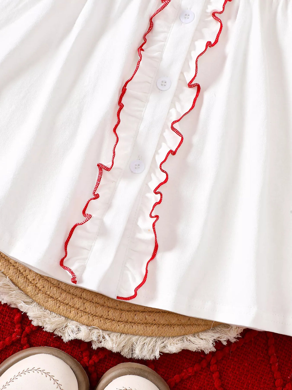 White dress with button front and red ruffled trim along the placket