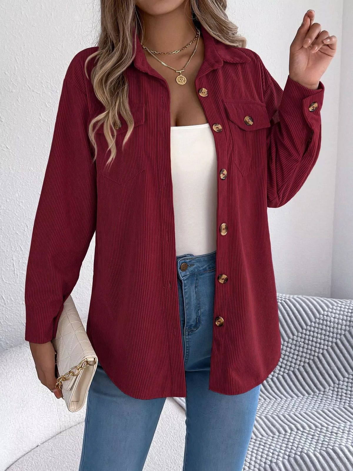 Wine red corduroy shacket front view with flap pockets and gold button accents