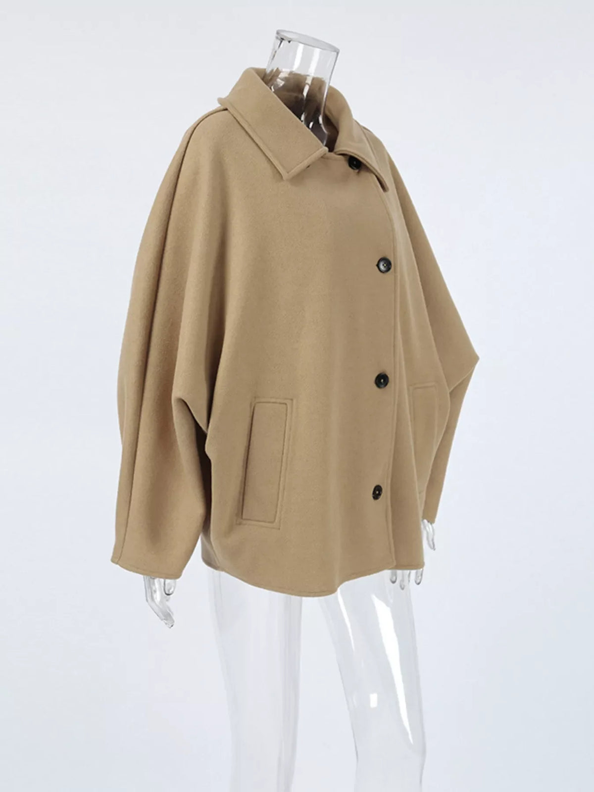 Khaki button-up coat on mannequin with notched collar and flap pocket details