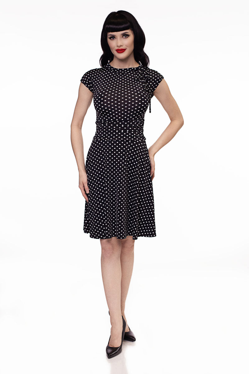 Black polka-dot fit-and-flare dress with cap sleeves and high neckline