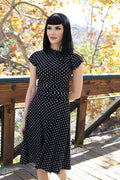Black polka-dot bombshell dress with short sleeves and high neckline
