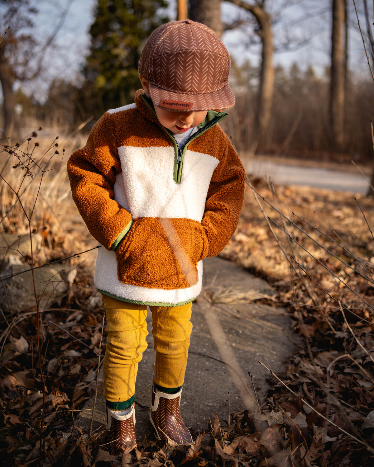 Brown sherpa pullover hoodie with white panel and green hood trim