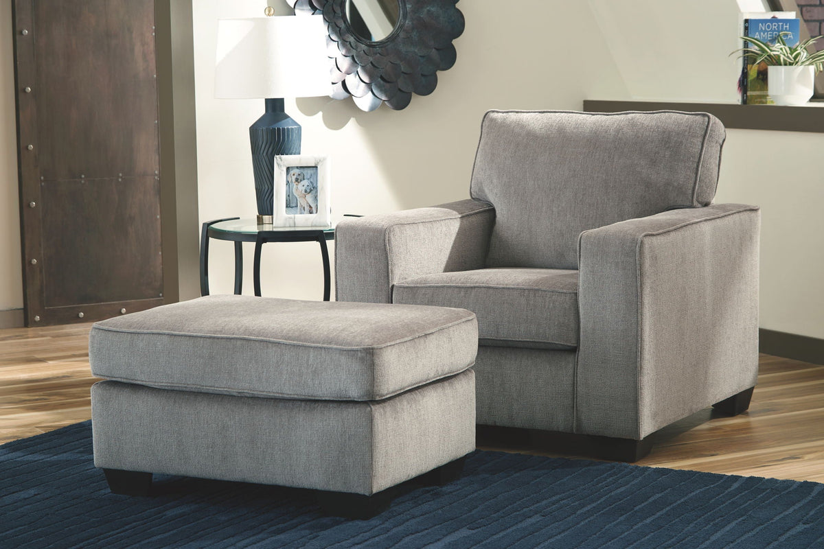 Light gray upholstered sofa chair with matching ottoman