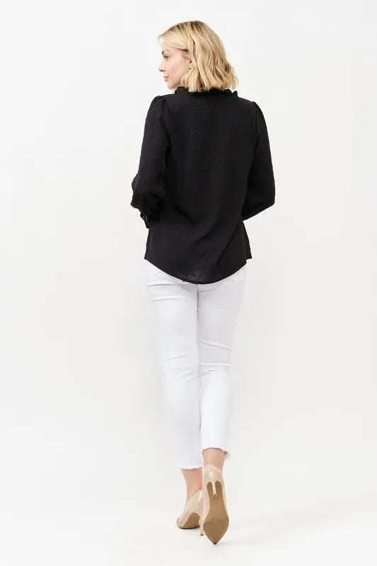 Black polka-dot blouse, back view with buttoned yoke and long sleeves