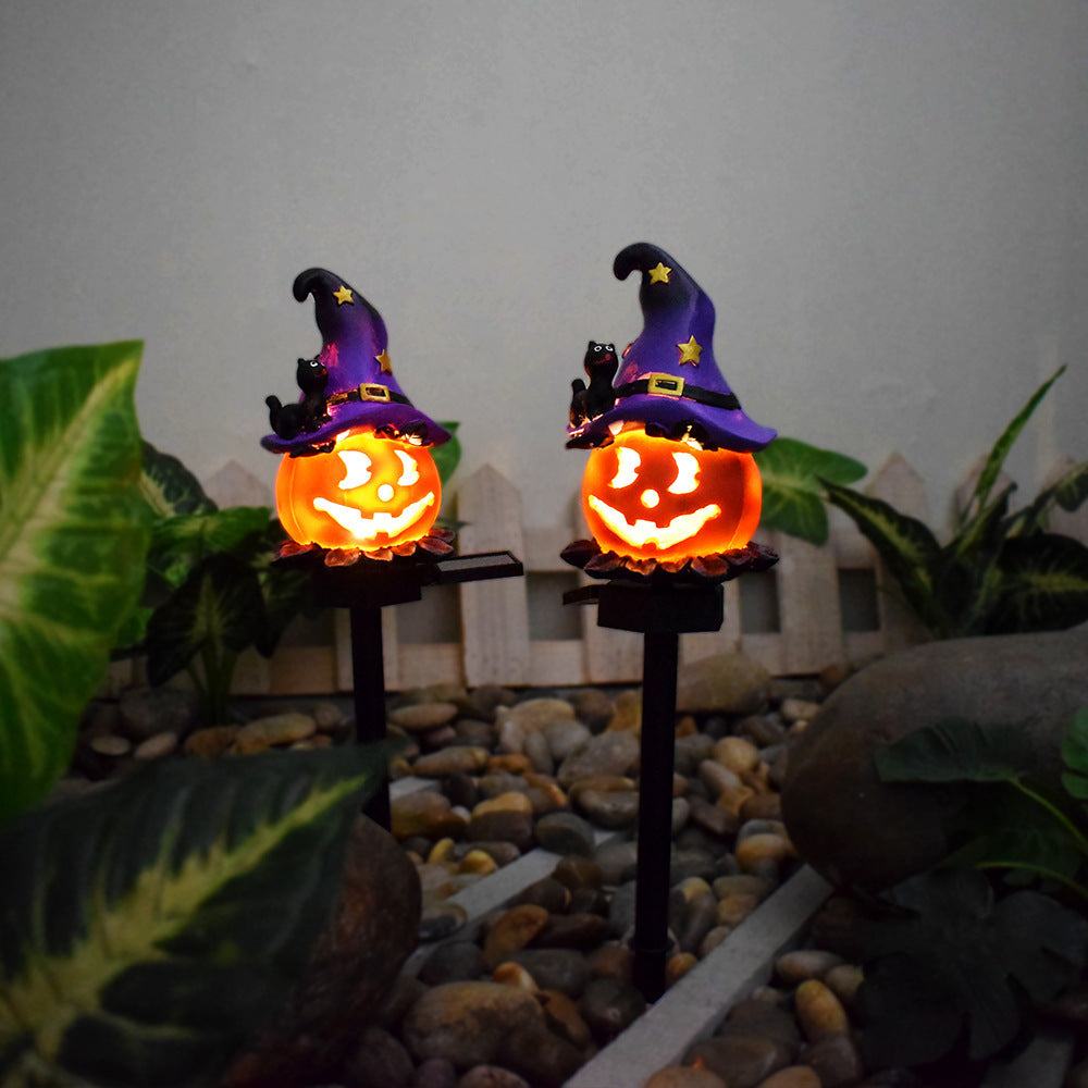 Solar Halloween pumpkin lantern stake light with purple witch hat and glowing jack-o’-lantern face