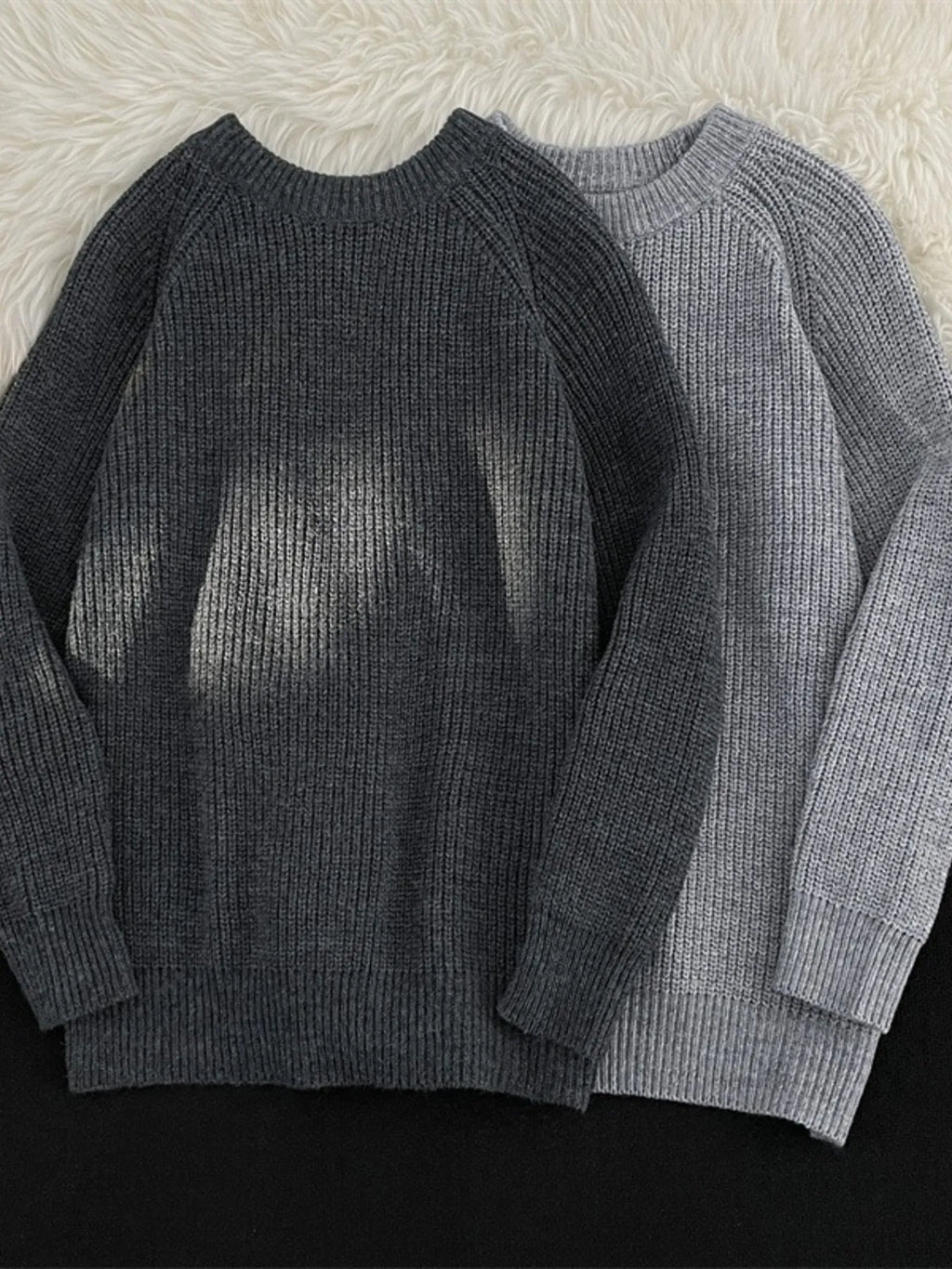Dark gray and light gray knit round-neck long-sleeve sweaters with ribbed cuffs