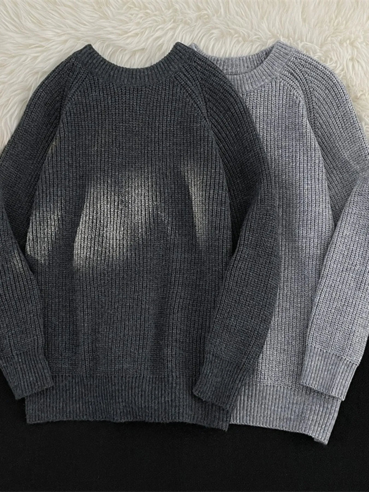 Dark gray and light gray knit round-neck long-sleeve sweaters with ribbed cuffs