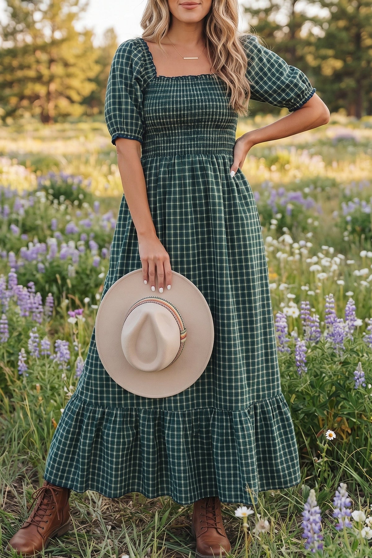 Green plaid square-neck shirred waist dress with puff sleeves and ruffled hem, worn with hat.