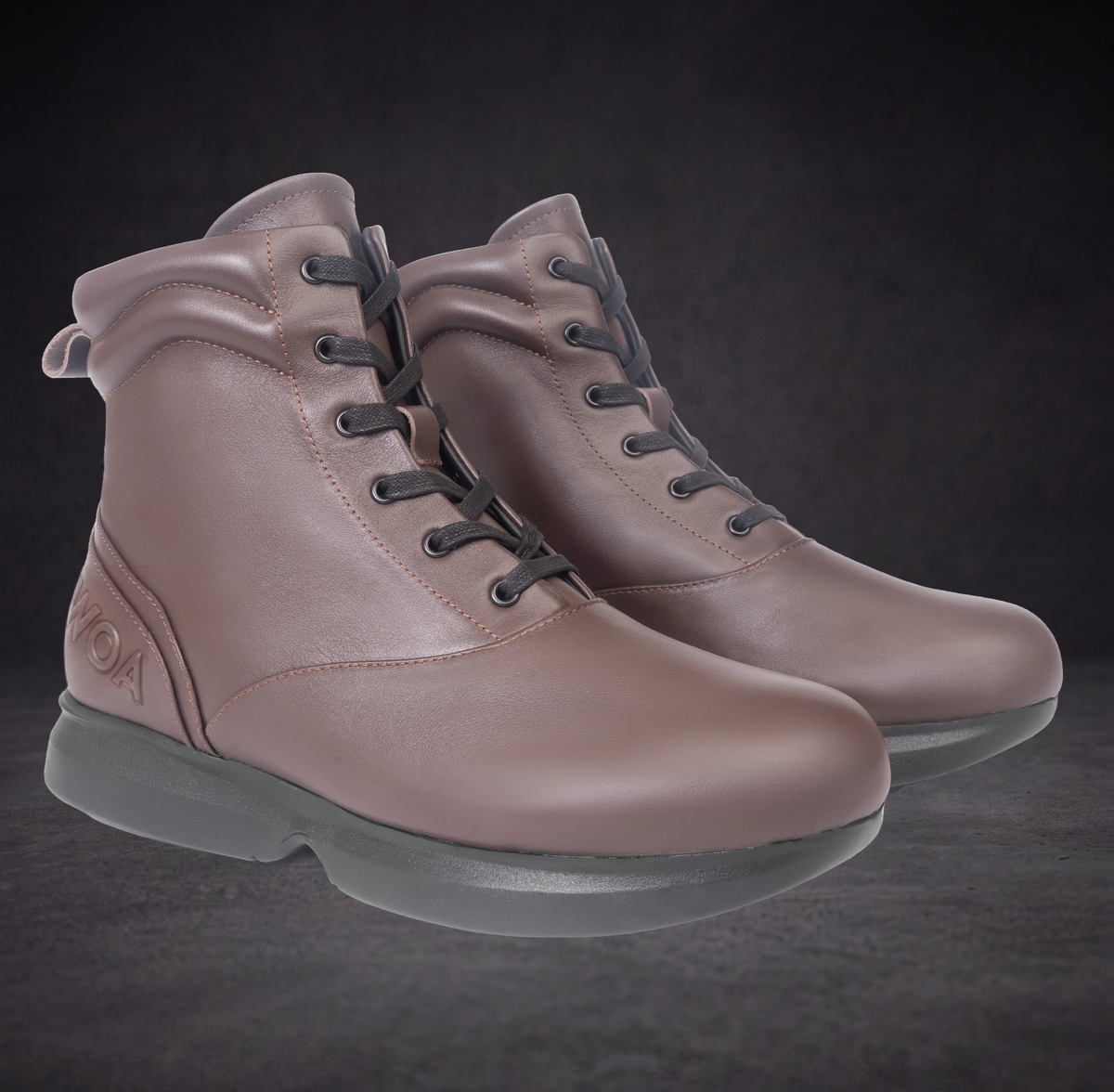 Pair of WOA taupe lace-up ankle boots with dark eyelets and textured rubber sole