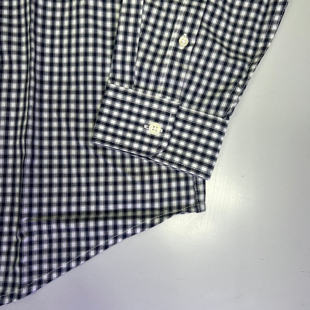 Men's checkered button-up shirt sleeve cuff with buttoned placket detail