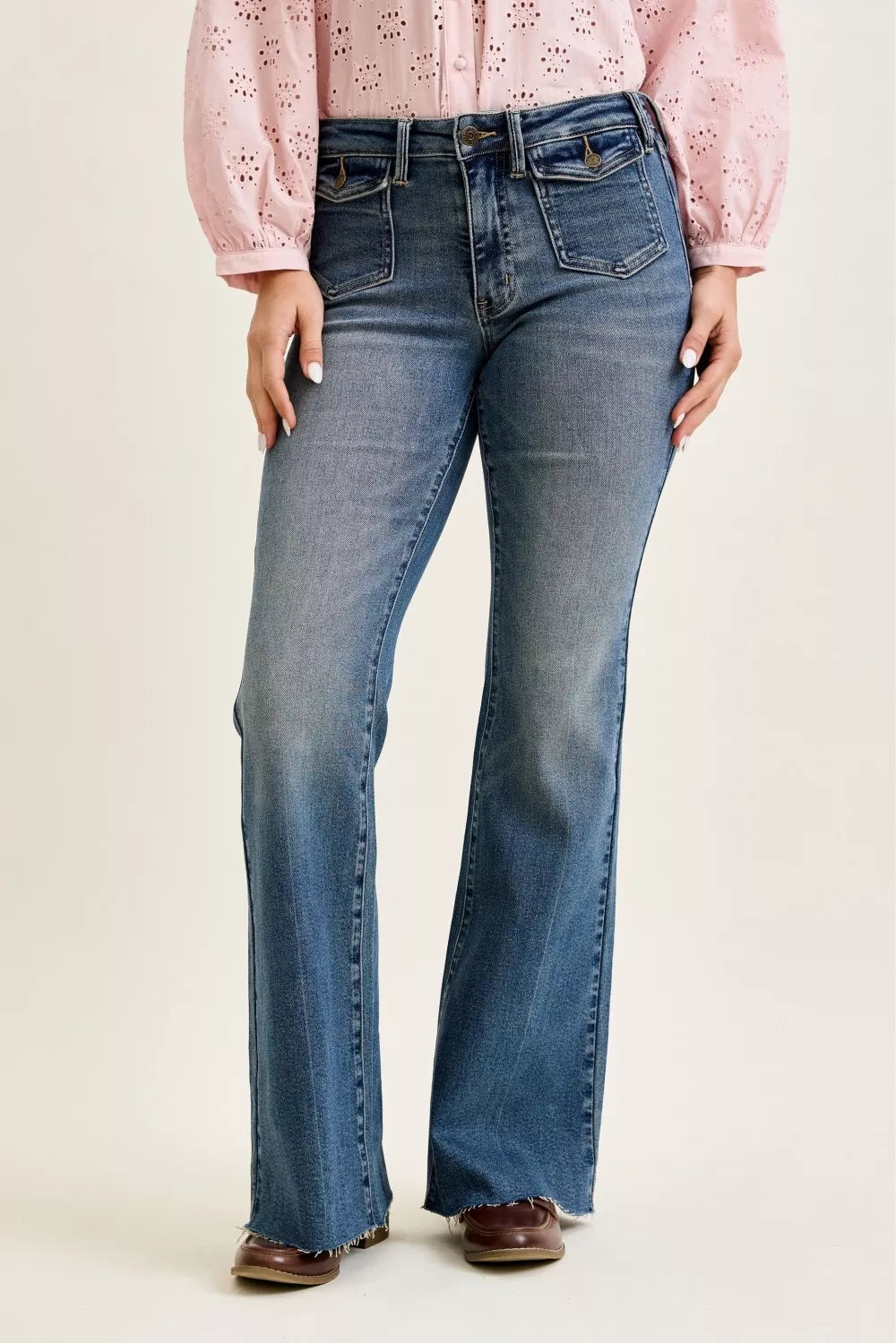 Mid-rise blue flare jeans with front flap pockets and button waistband