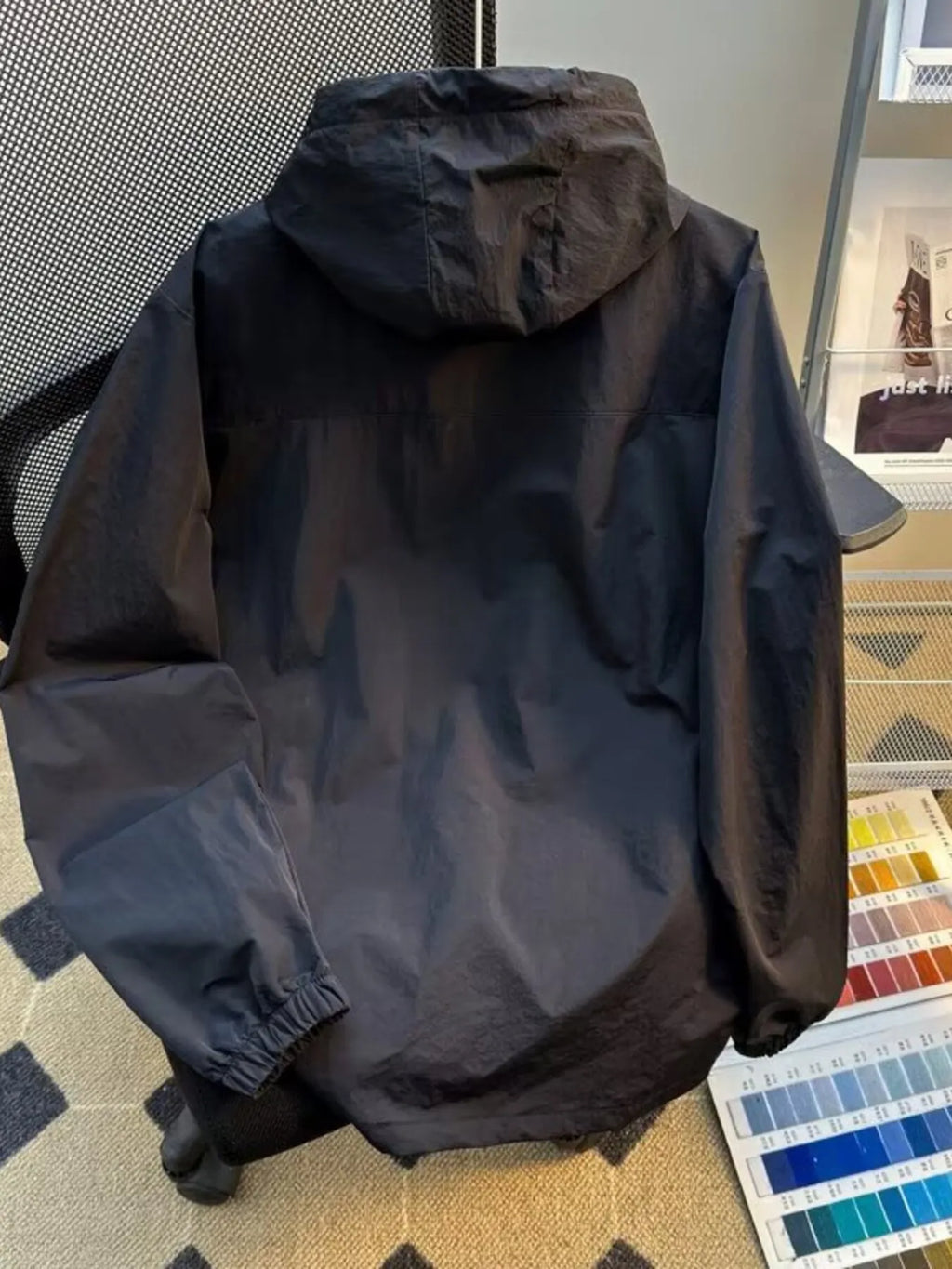 Lightweight hooded windbreaker jacket in dark gray with hood and elastic cuffs