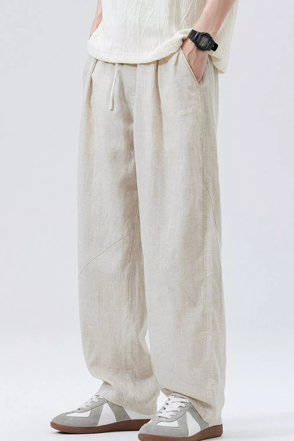 Cream linen-look drawstring pants with roomy wide legs and side pockets