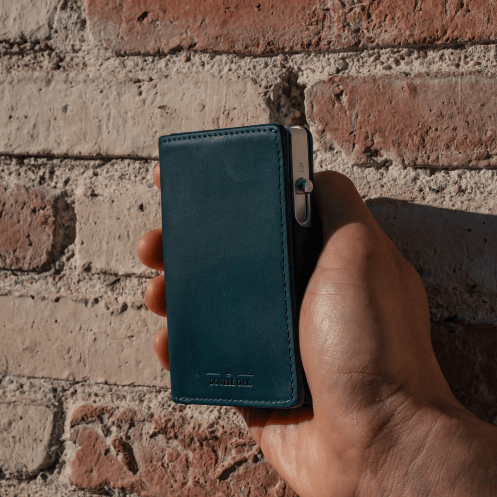 Teal bifold wallet with card slots and snap closure, leather look.