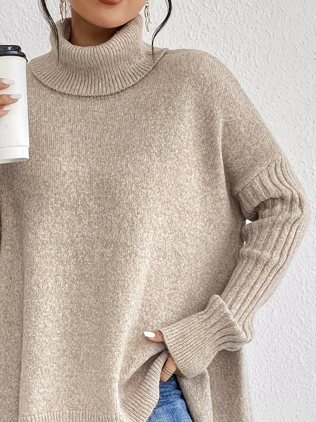 Grey knit turtleneck sweater with ribbed cuffs and asymmetrical high-low hem