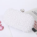White pearl beaded clutch with round metal clasp, close-up side view