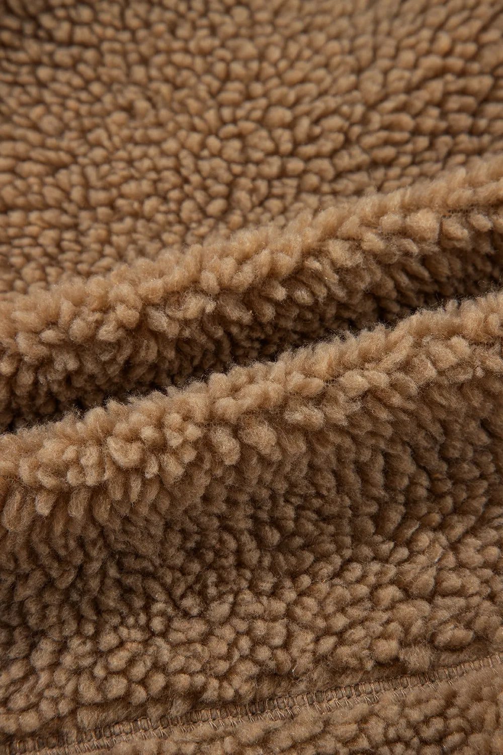 Brown fleece zip-up hooded jacket fabric close-up with textured sherpa-style pile