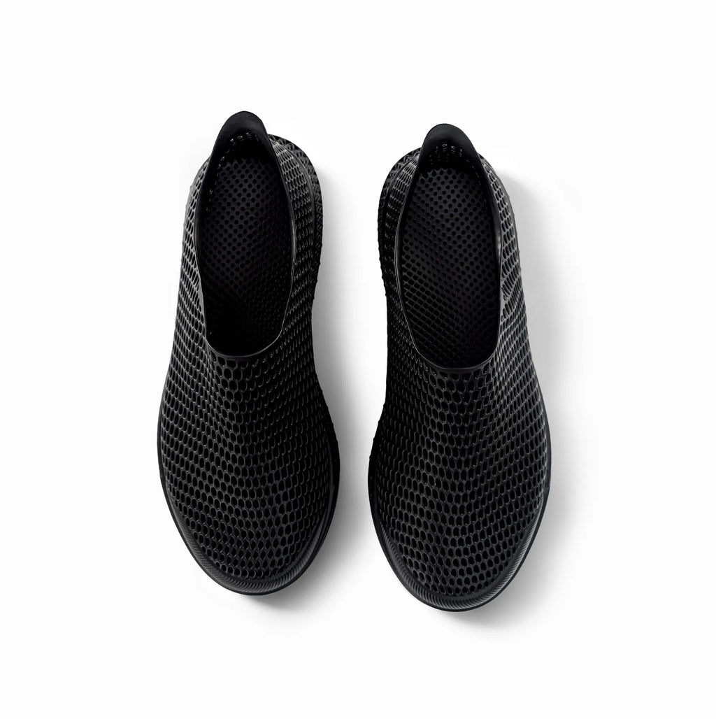 Pair of black 3D-printed casual sneakers, side view showing perforated mesh upper