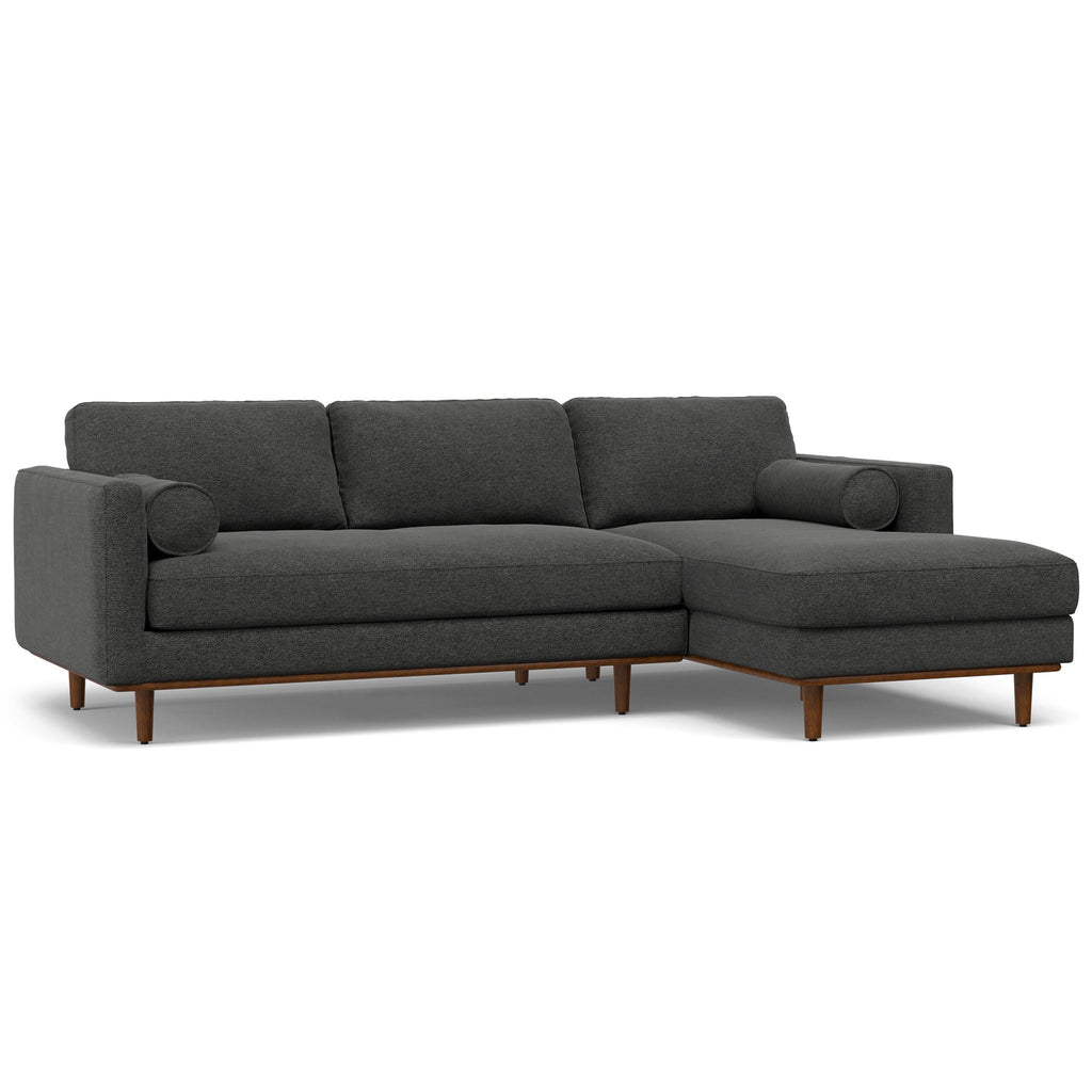 Dark gray fabric sectional sofa with three back cushions and chaise extension