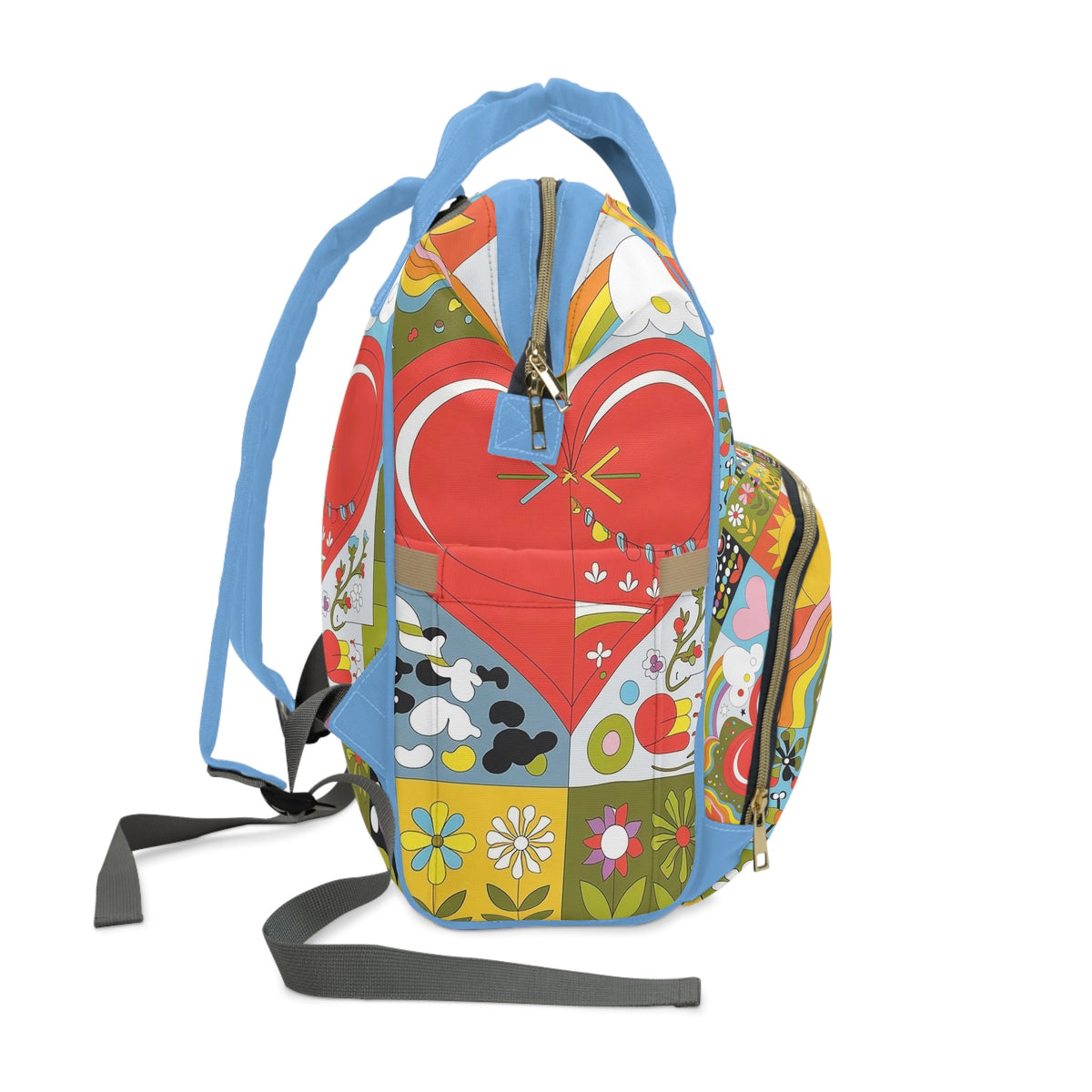Diaper backpack standing view, colorful heart quilt, blue webbing straps and hanging tags