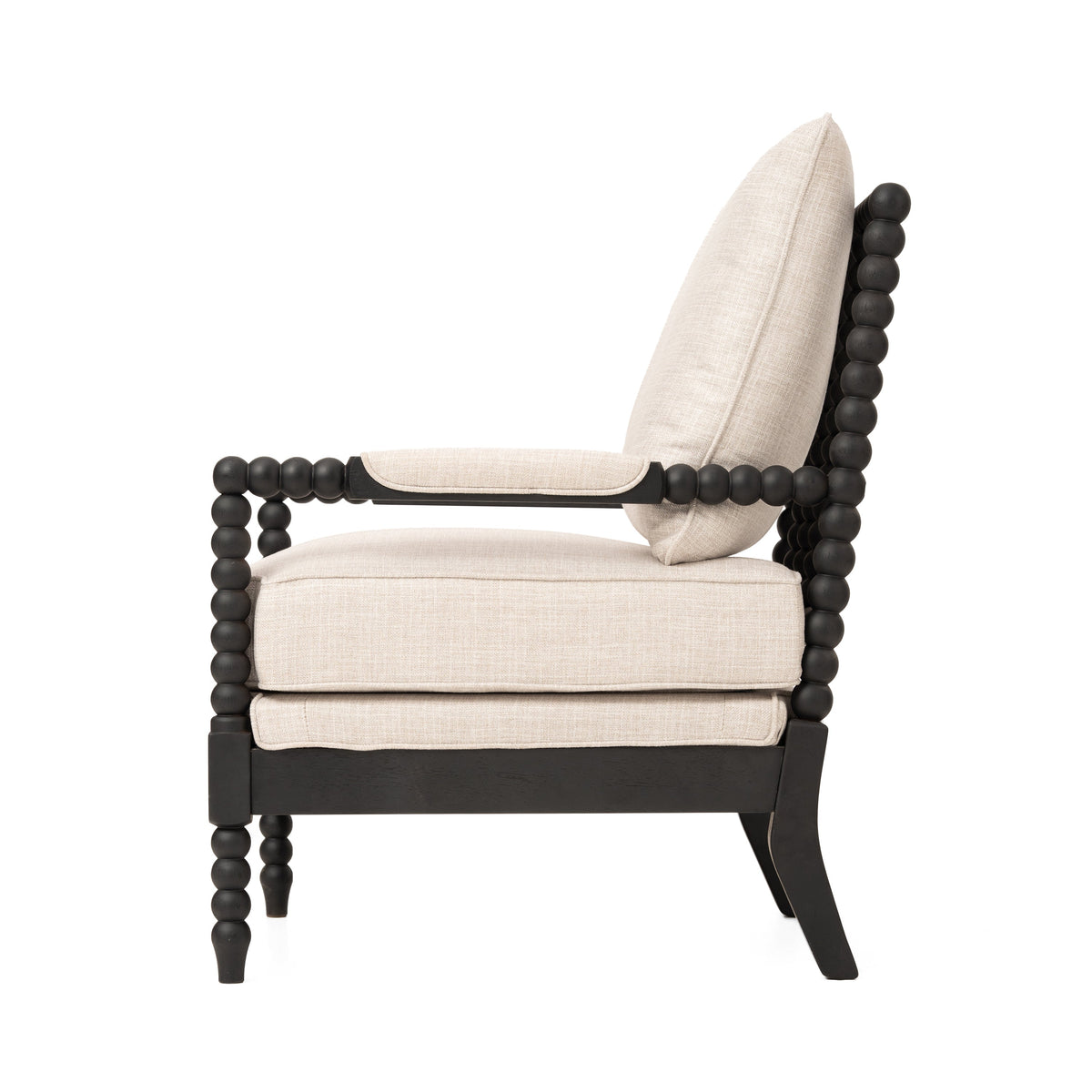 Side view of an accent chair with beige cushions, dark wood bead-style arms, and curved legs