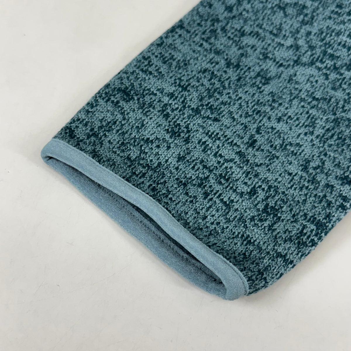 Men's teal fleece jacket cuff with ribbed contrast trim