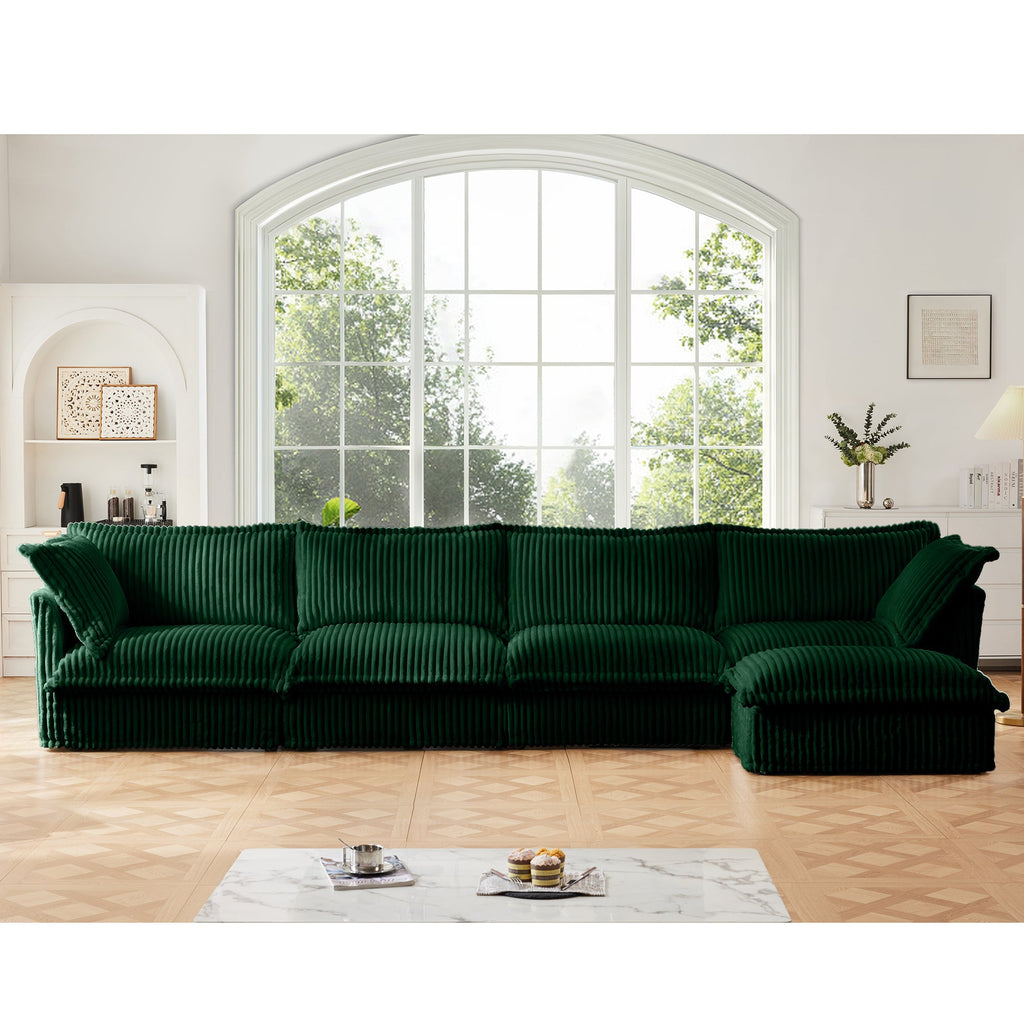 Green L-shape sectional sofa with chaise, ribbed slipcover, plush back and seat cushions.