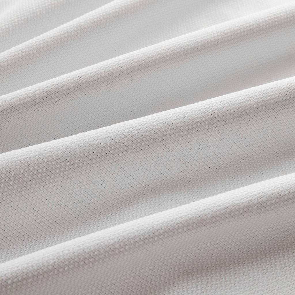 White blackout curtain fabric panel with subtle woven texture close-up