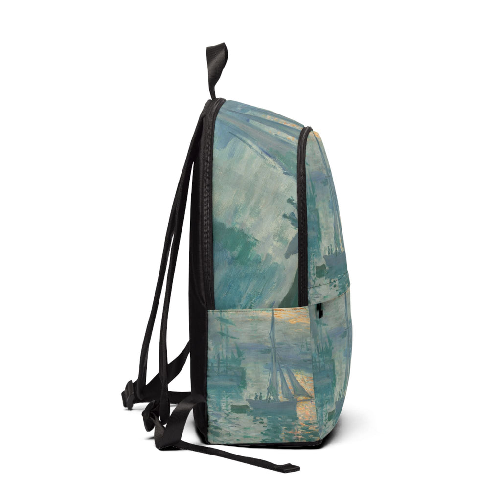 Side view of ocean art fabric backpack with black shoulder straps and handle