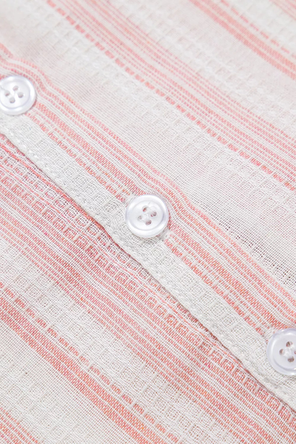 Dusty pink striped blouse front with white button placket and three visible buttons