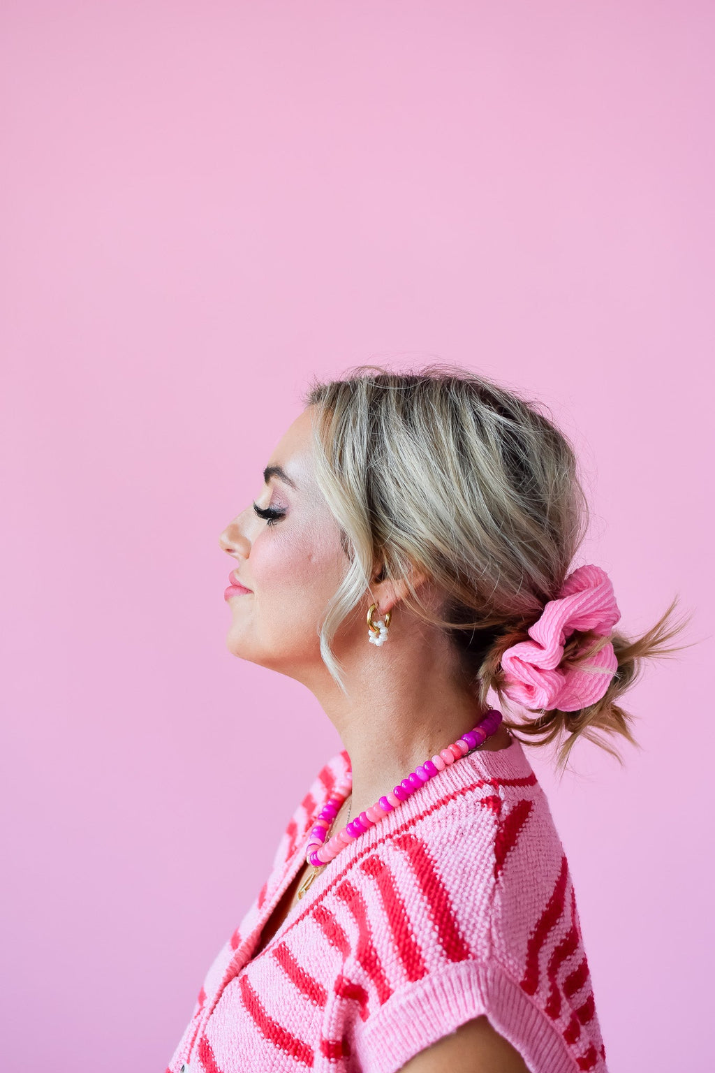 Pink ribbed scrunchy on a low side bun
