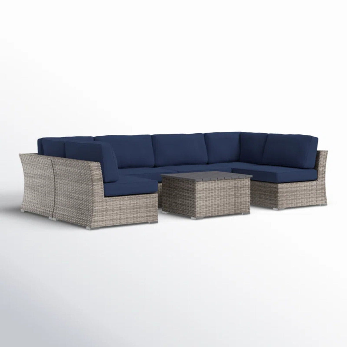 Gray wicker sectional sofa with blue cushions and square coffee table