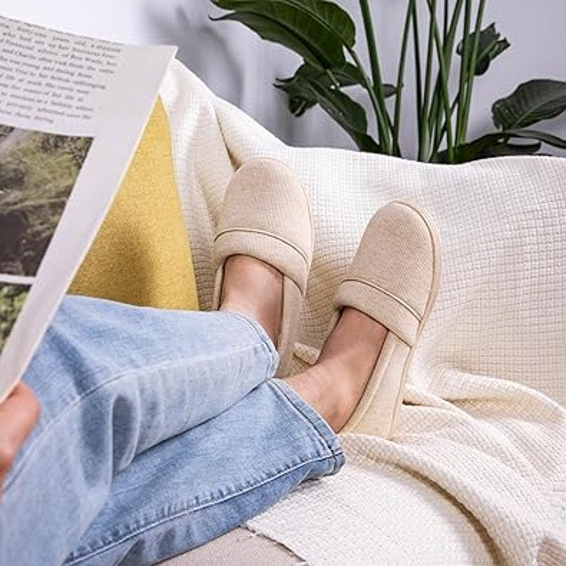 Tan slip-on loafer slippers being worn with jeans, fabric upper