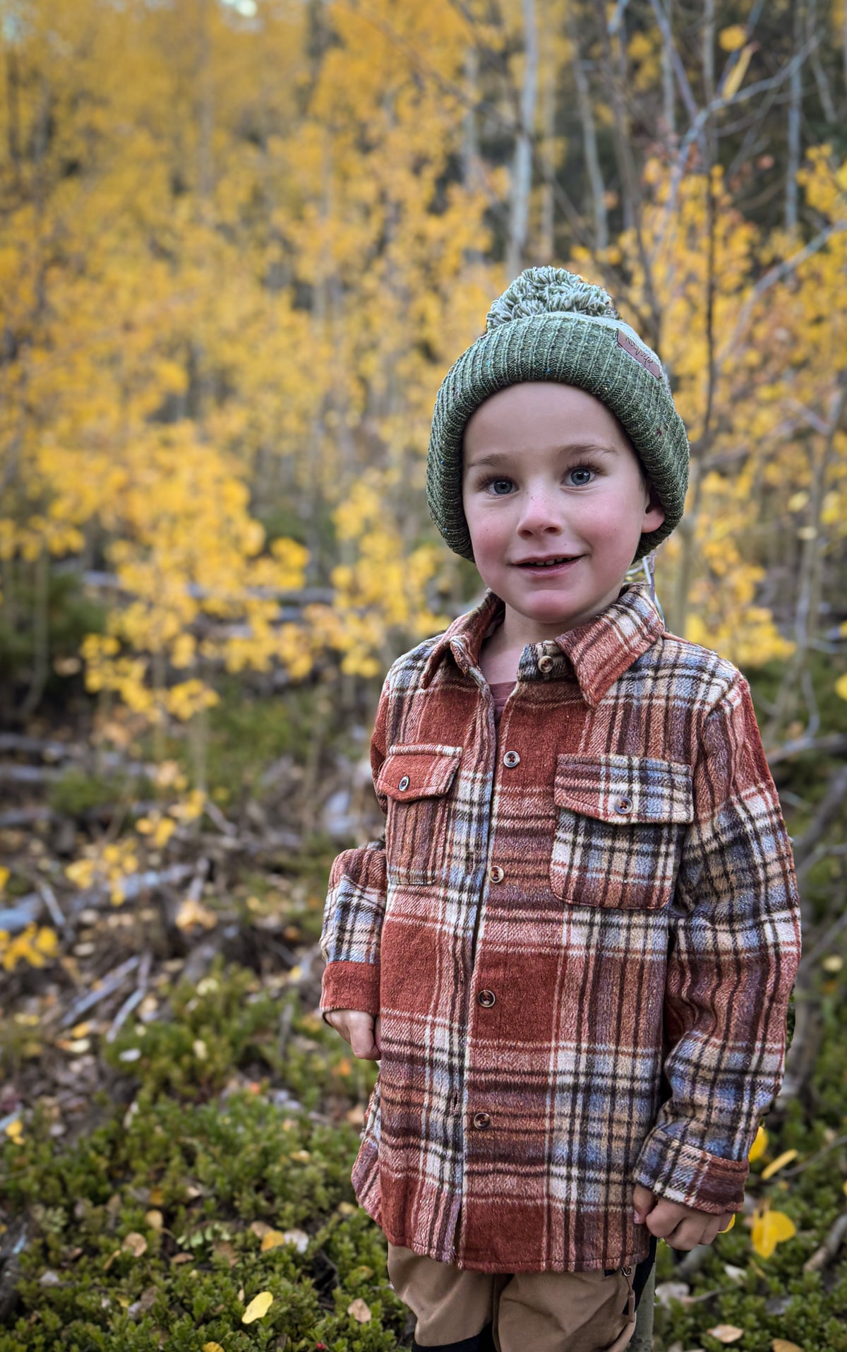 Plaid flannel button-up shirt in red and tan, with chest pockets