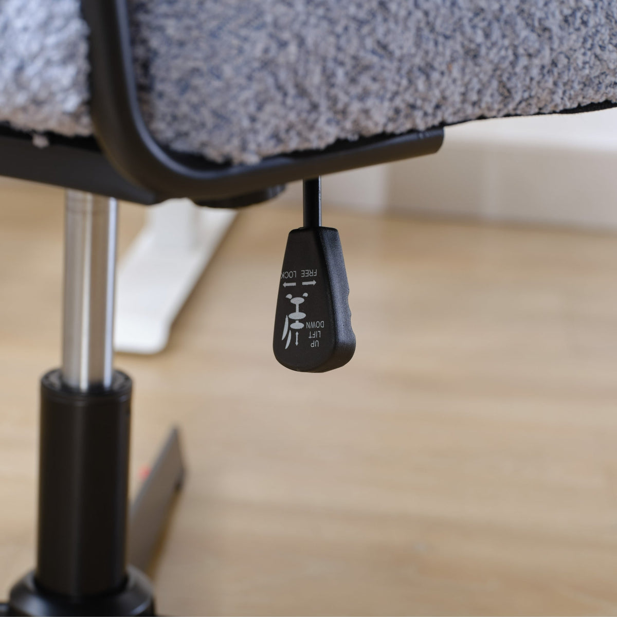 Black chair gas-lift base with control knob underside