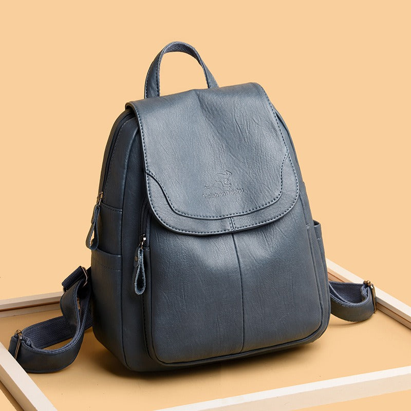 Blue front flap backpack with curved pocket, side zipper, and adjustable shoulder straps