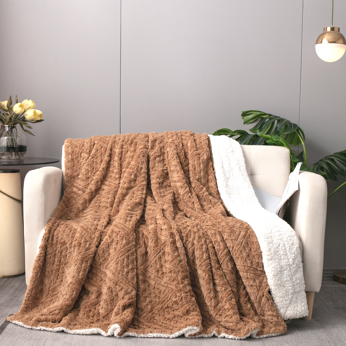 Caramel brown faux fur throw blanket with embossed chevron texture and white border