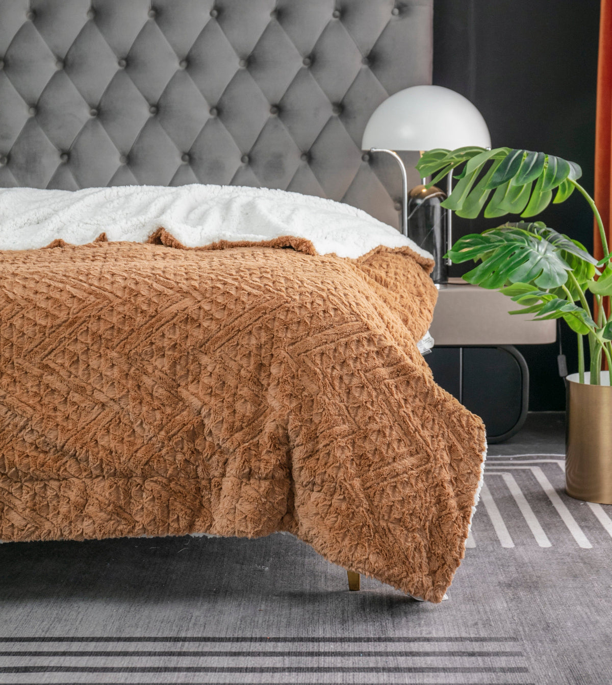Caramel brown faux fur throw blanket with embossed chevron pattern and white backing