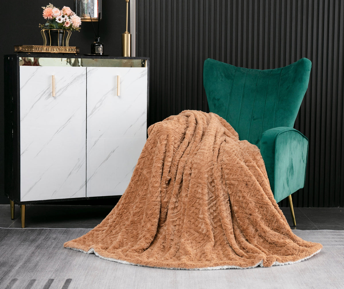 Caramel brown faux fur throw blanket with embossed chevron texture, draped over chair