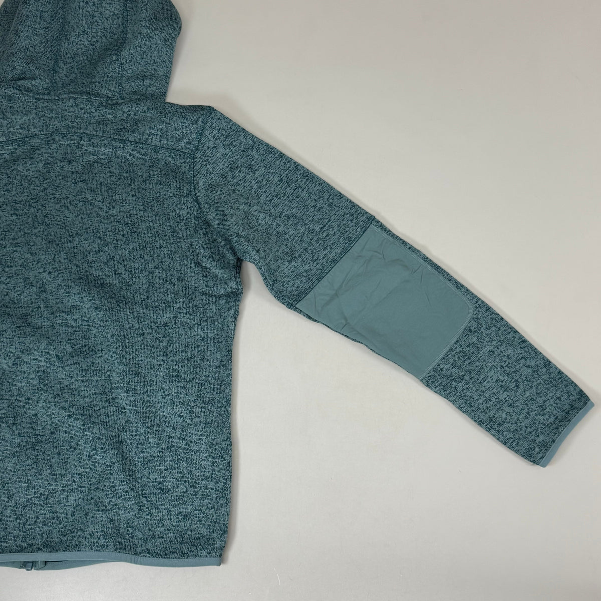 Men's teal fleece full-zip jacket sleeve with contrast cuff panels