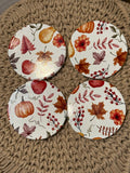 Round ceramic coasters with autumn leaves and pumpkins, four-piece set.