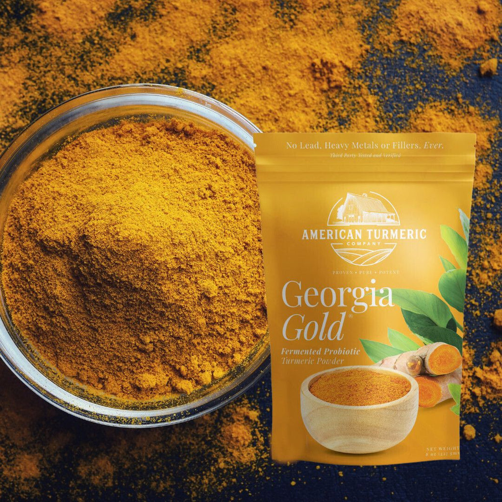 Bowl of fine golden turmeric powder beside turmeric powder pouch